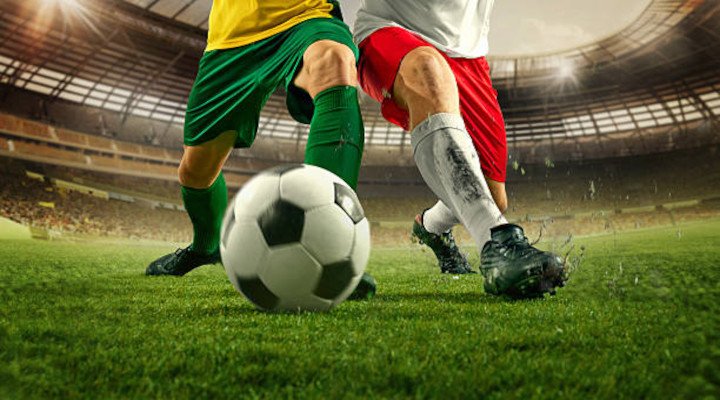 Two football players and a ball on the pitch